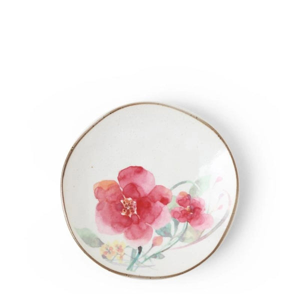 A small ceramic plate with a floral design with a brown rim.