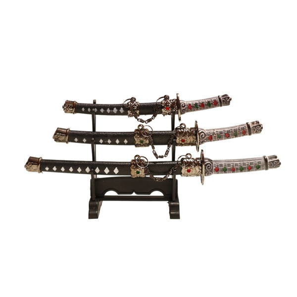 3 replica samurai sword letter openers on a display stand