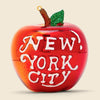 Glass ornament of The Big Apple with New York City written on it.