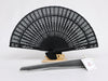 Black carved wooden fan with organza bag