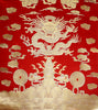 Gold brocade sea dragon on red fabric