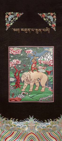Brocade print monkey on elephant in forest.