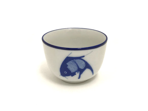 Vintage tea cup with a dark blue carp and blue mouth rim.