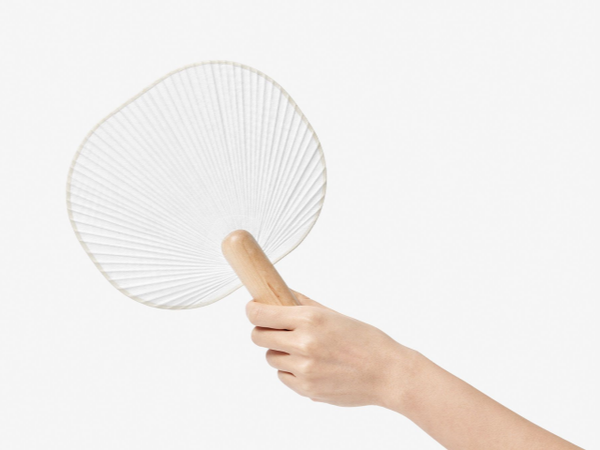 geometric paper fan being held by someone