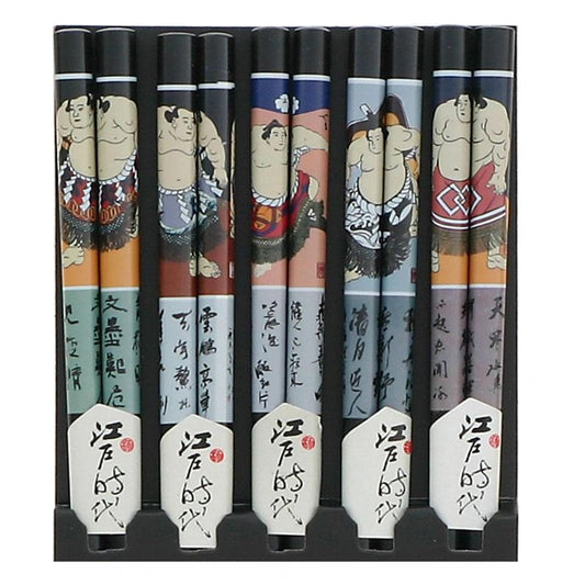 A set of five pairs of chopsticks with assorted sumo designs on each, displayed in a row against a white background.