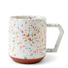 multicolored specks on white mug