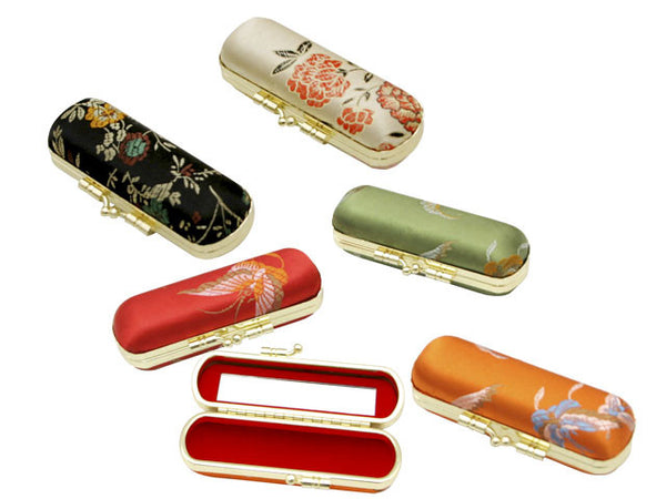 Brocade Lipstick Case in 5 assorted colors. One lipstick case is open.