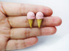 Hand holding pink ice cream earrings