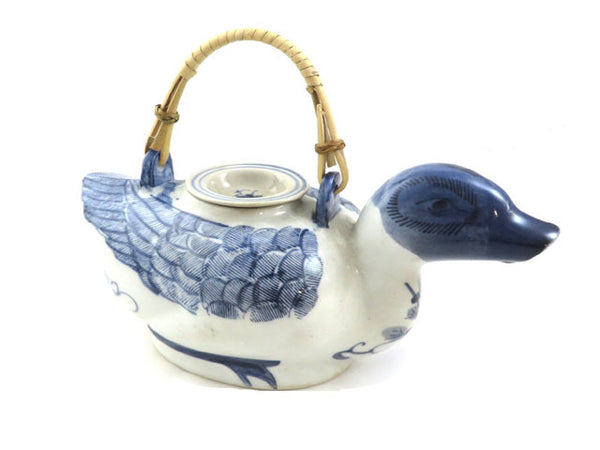 quaint hand-painted blue and white ceramic duck shaped teapot with classic bamboo handle