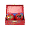 A pair of red cloisonné metal balls in a red box
