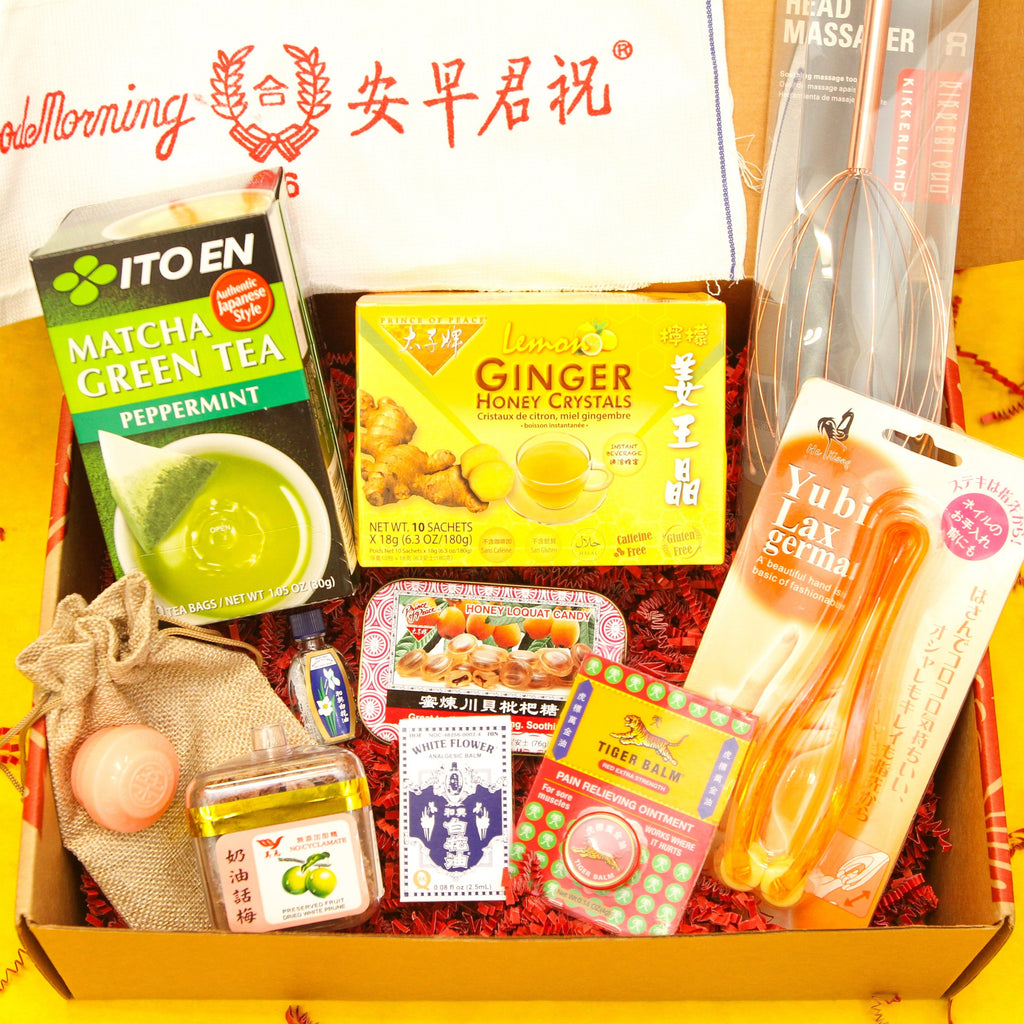 gift box containing Gua sha tool, Copper head massager, Finger massager, Ping On ointment, Tiger balm, White flower analgesic oil, Preserved plums, Honey loquat cough drops, Ginger honey tea, Peppermint matcha tea, Good Morning towel