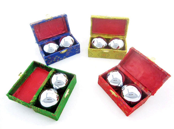 Green, Blue, Yellow, and red boxes each holding a pair of chrome metal therapy balls