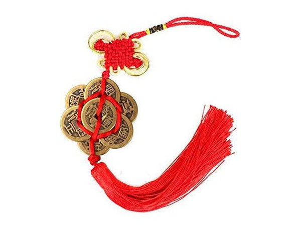 coins ornament with red tassel. Six coins forming a hex shape. with one on top of the other six. the knot's borders are a gold color