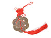 coins ornament with red tassel. Six coins forming a hex shape. with one on top of the other six