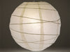 White paper lantern with modern swirl ribbing. A lightbulb is inside to illuminate the lantern.