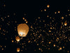 Group of Sky lanterns flying in the night sky