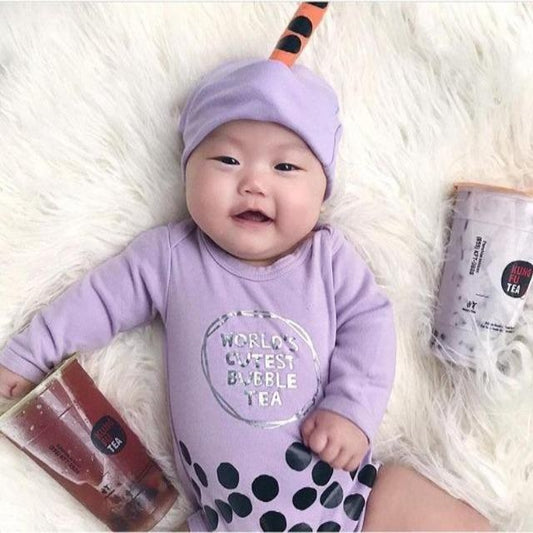 Adorable baby in purple "bubble tea" onesie