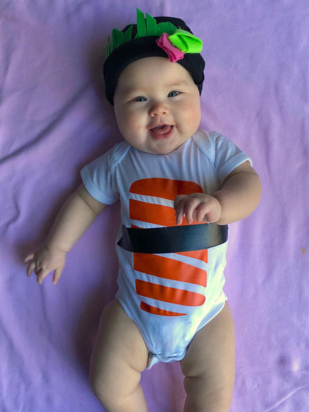 Chubby baby in a sushi onesie and cap