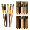 Five pairs of natural wood color chopsticks in assorted colors and shapes