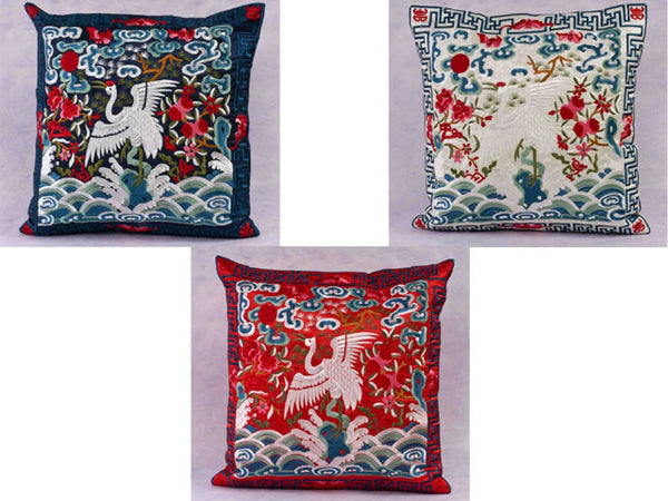 Gorgeous embroidered pillows with a crane design in three motifs: light blue on dark blue, light blue on white, and blue on red