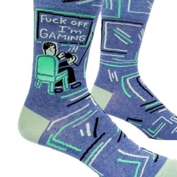 Blue socks with a person sitting in a chair gaming in front of screen that reads "fuck off I'm gaming"