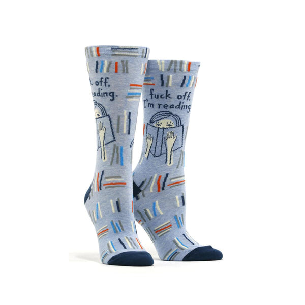 Blue women's sock with woman with book and text, "Fuck off I'm reading"