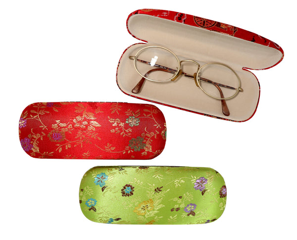 Red and green eyeglass cases in floral brocade pattern with glasses