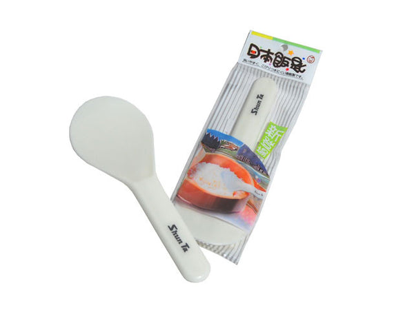 Plastic rice paddle/ rice scoop next to its packaging