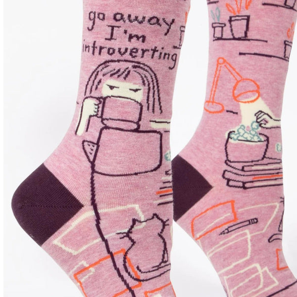 Go Away, I'm Introverting Novelty Socks: person drinking tea at their laptop in the dark with books and their cat