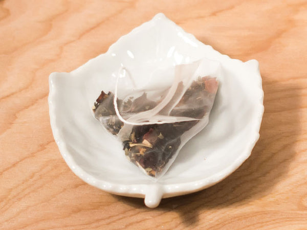 White Porcelain Tea Bag Caddy / Sauce Dish - Leaf design with bag of tea on top