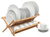 Bamboo dish rack holding different sized dishes as well as mugs 