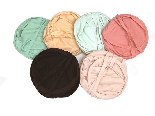 cotton sun hats folded. The colors they come in are Aqua Green, Peach, Mint, Coral, Black, and Pink.