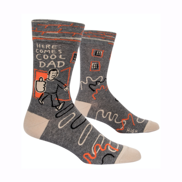 Grey sock with cream and orange accents, illustration of person coming through the door with a big thumbs up saying "Here comes cool dad"