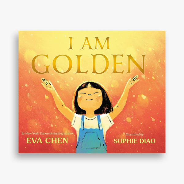 Cover of I Am Golden: small asian girl with denim overalls and her arms outstretched ona peach background with gold light shining on her