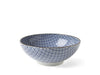 A white bowl intricately lined with a blue crossed mosaic 