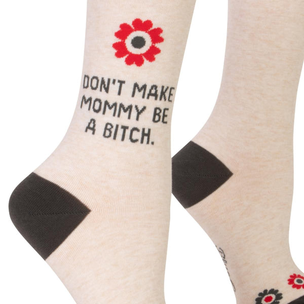 Off-white socks that say "Don't make mommy be a bitch" with grey accents and red and grey flowers