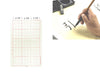 9x15 grid Calligraphy sheet. 15 red squares, with one length of the square measuring 2.875", organizing this grid. On the right is a person writing a character on the sheet