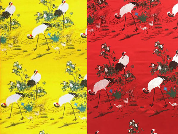 Cranes in Garden Field Design Brocade Fabric. Yellow and Red color designs are side by side.