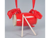 Waist drum dangling in the air by the shoulder strap. Drum sticks are leaning on the drum