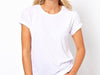 Feminine figure donning Swan Brand's fitted to comfort white tee with rolled sleeves