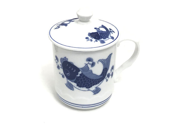 Two playful blue carps designed on a ceramic mug with lid and a Chinese stamp on the body of the mug for a vintage feel